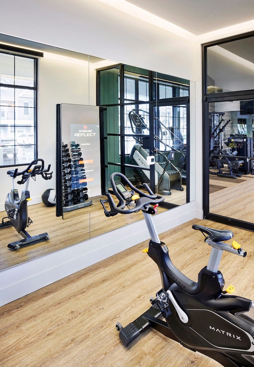 a gym with exercise bikes and mirrors