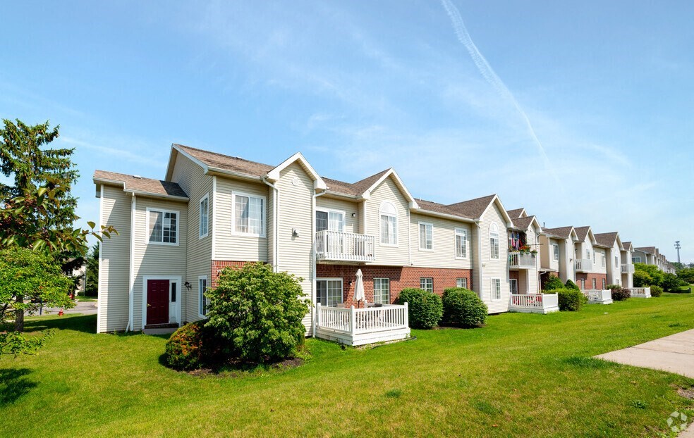 a row of town houses on a green lawn