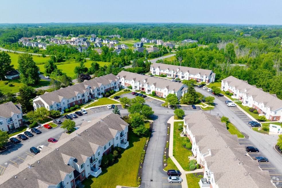 an aerial view of a neighborhood of houses with cars parked