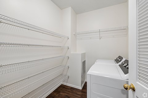A white laundry room with a washer and dryer.