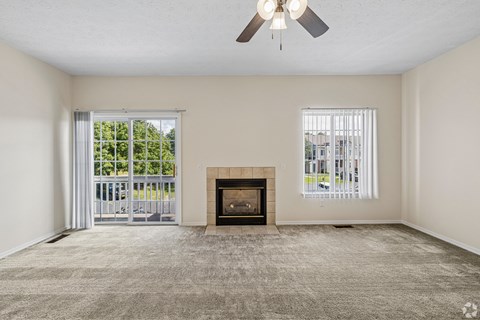 A room with a fireplace and a ceiling fan.