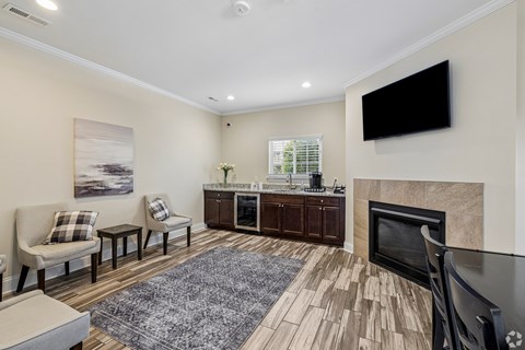 A living room with a fireplace and a television mounted on the wall.