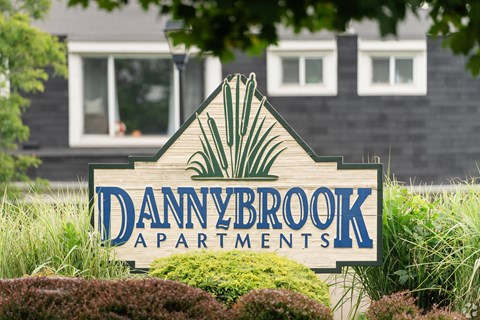 A sign for Dannybrook Apartments is displayed in front of a building.