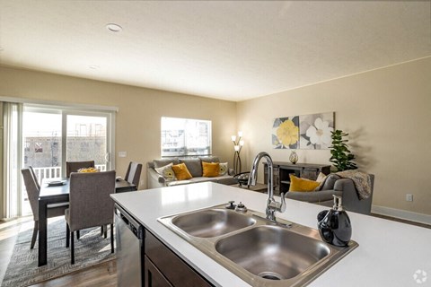 a kitchen and living room with a sink