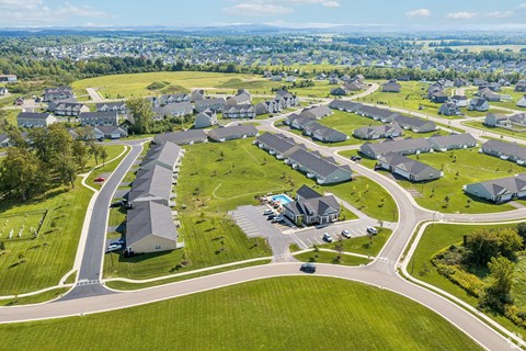 A bird's eye view of a residential area with houses and roads.
