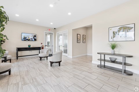 A living room with a couch, chairs, and a coffee table.