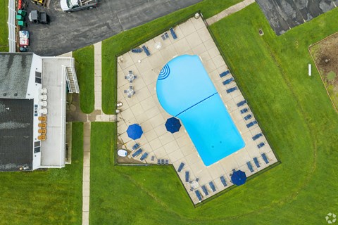 A large blue pool with a smaller pool next to it.