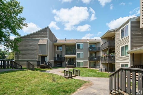 Apartment complex with a walkway between the buildings.
