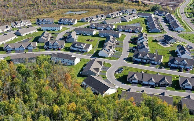 an aerial view of a suburban neighborhood with houses and roads