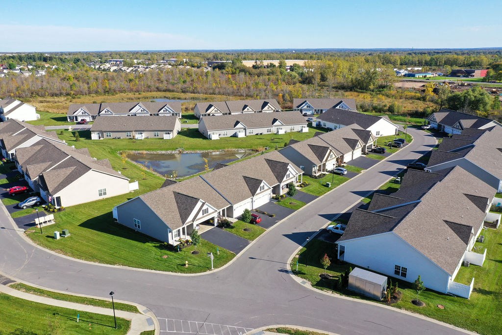 an aerial view of a neighborhood of houses with converging roofs
