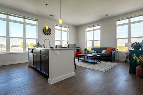 a kitchen and living room with a counter top