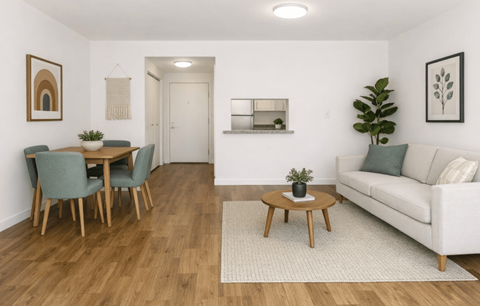 A living room with a dining table and chairs.