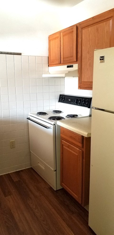 a kitchen with a stove and a refrigerator