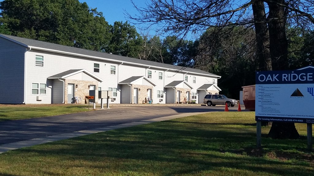 a sign in front of a white building