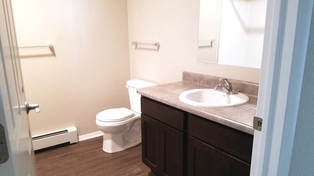 an empty bathroom with a toilet and a sink