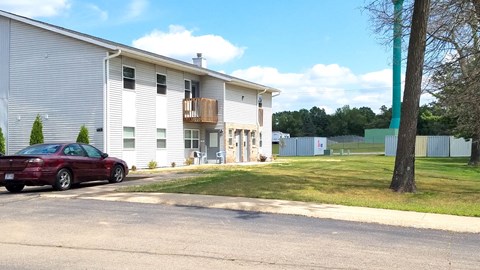 a house with a red car parked in front of it