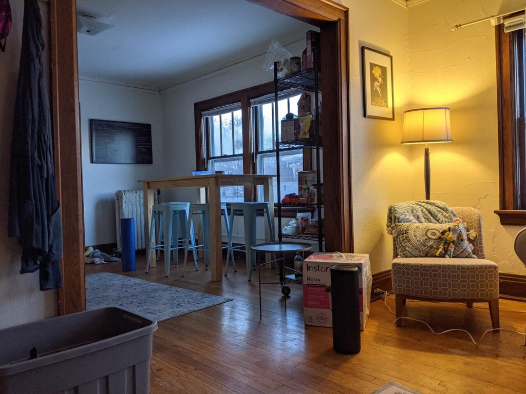 A room with a chair and a table in it.