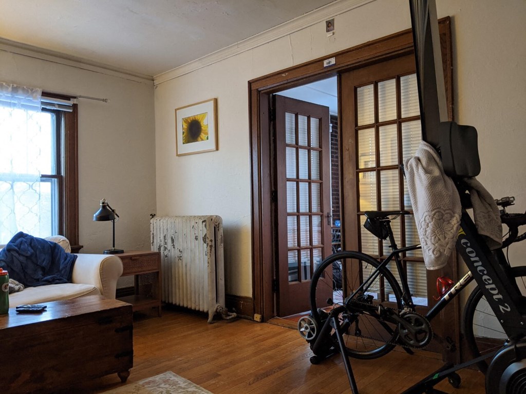 A room with a bicycle leaning against a wall.
