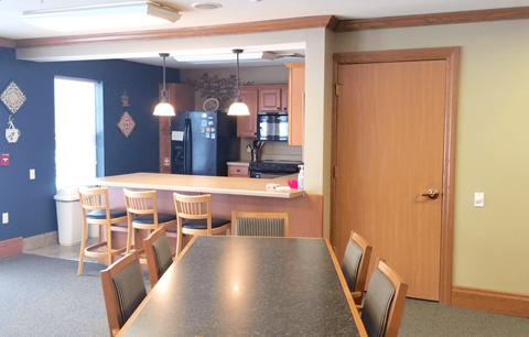 a dining room table with a kitchen in the background