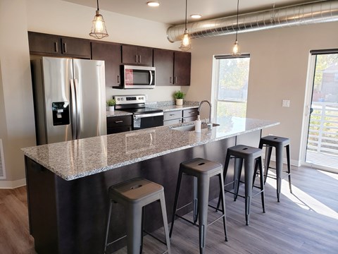a kitchen with a granite counter top and stainless steel appliances