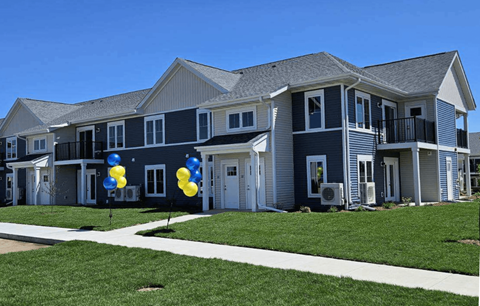 an apartment building with balloons in front of it