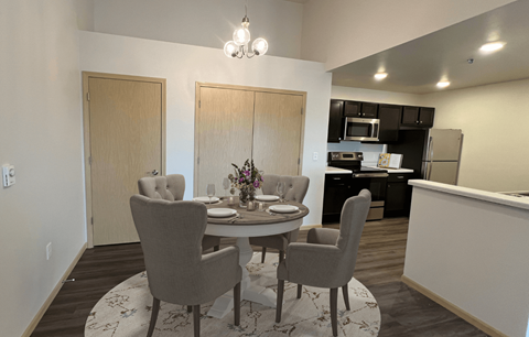 a dining room and kitchen with a table and chairs
