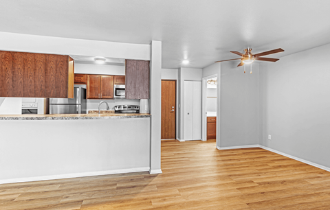 A kitchen with wooden cabinets and a white counter.