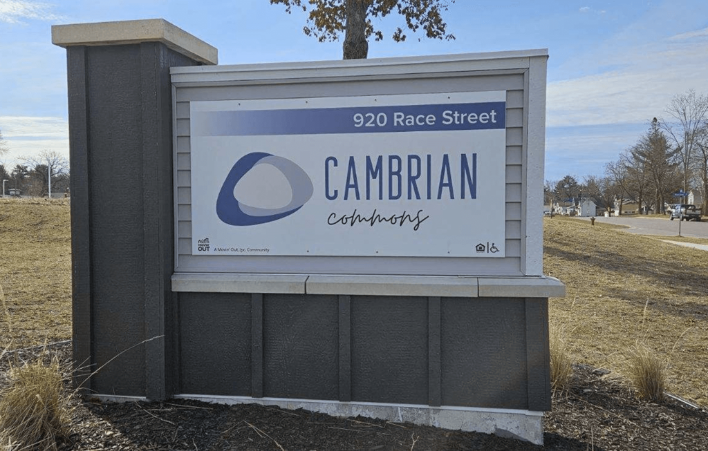 a sign for the cambrian corporation in front of a field