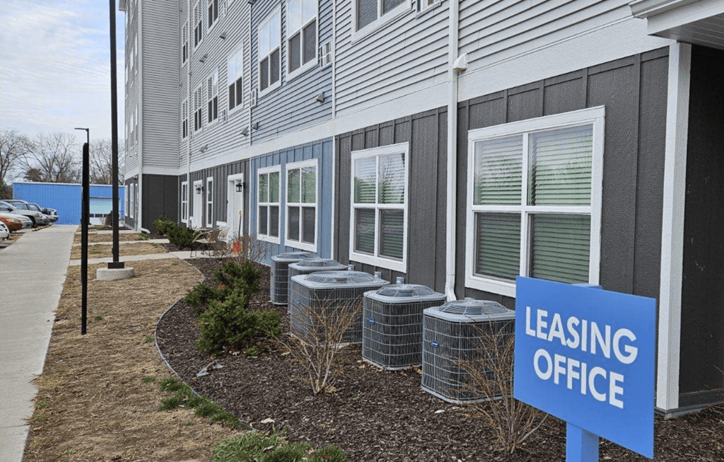 a leasing office sign in front of a building