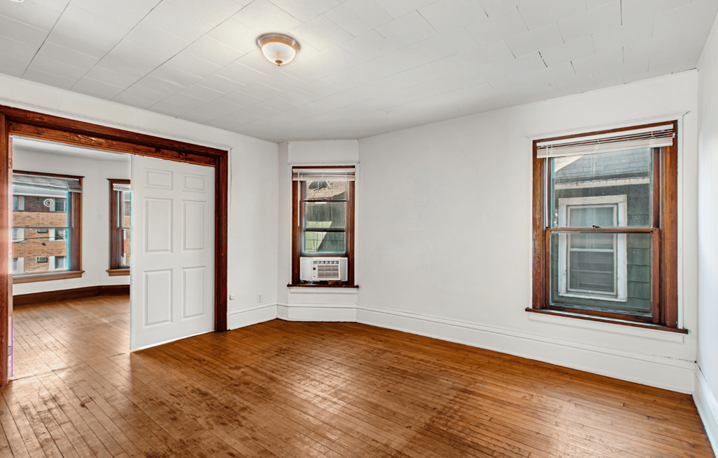 A room with wooden floors and white walls.