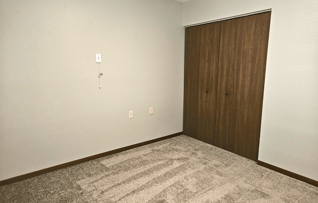 an empty room with a wooden door