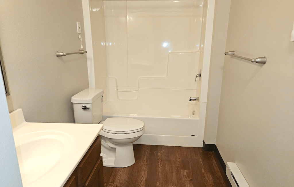 a bathroom with a toilet sink and shower