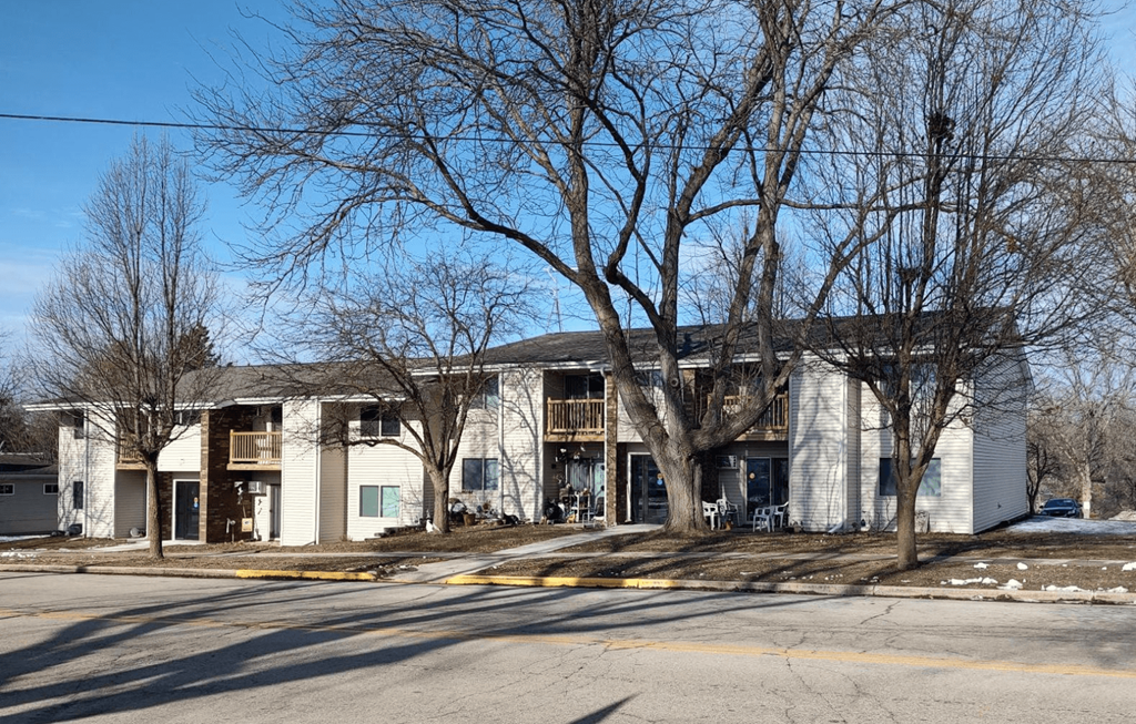 a white building with trees in front of it