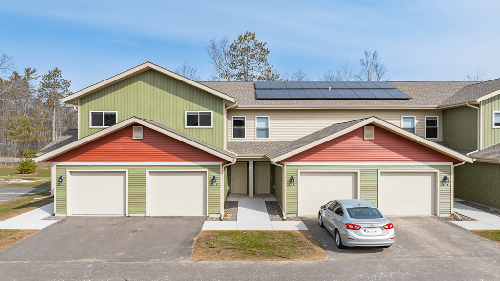 A house with a car parked in front.