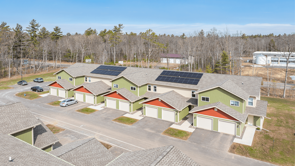 A large building with a parking lot in front of it.