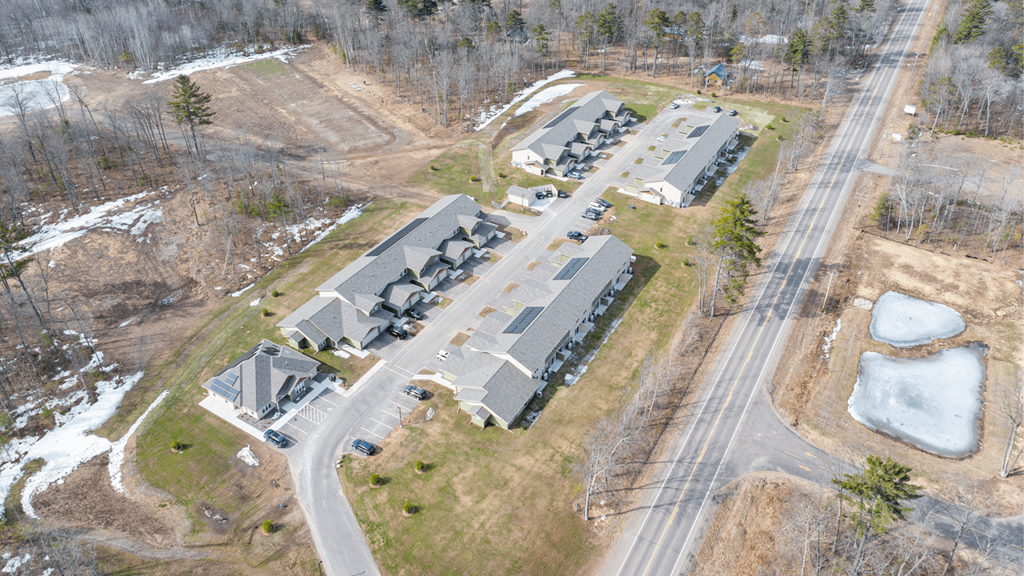 A road runs through a housing development.