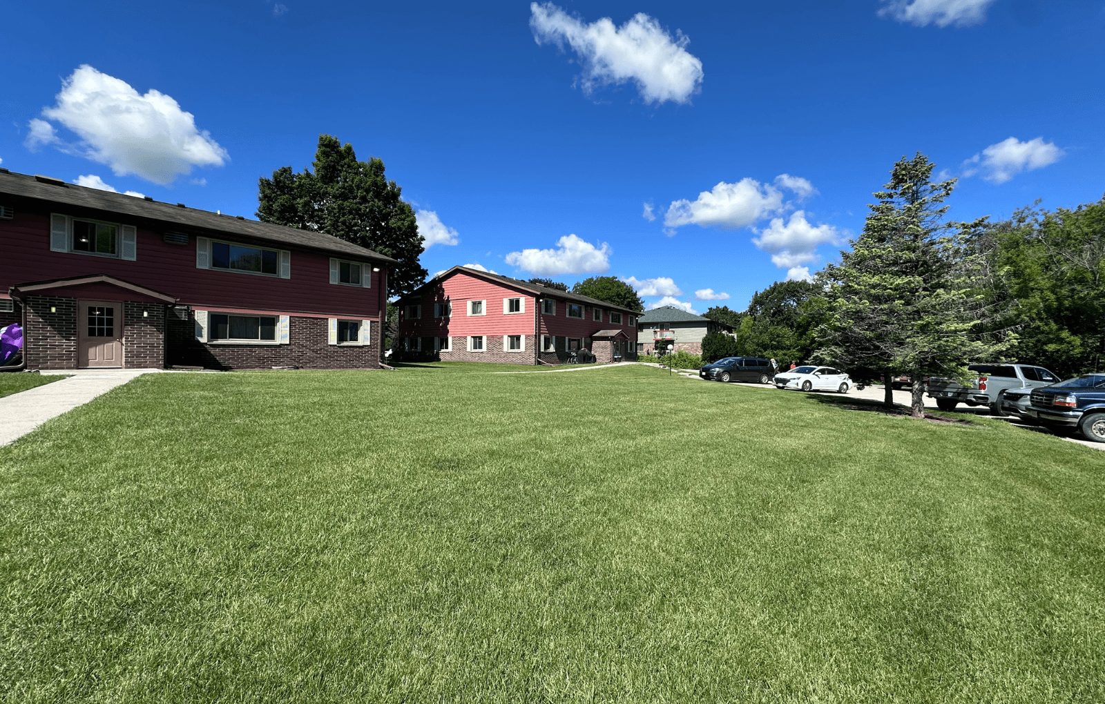 A grassy field with a building in the background.