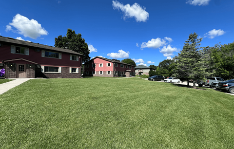 A grassy field with a building in the background.
