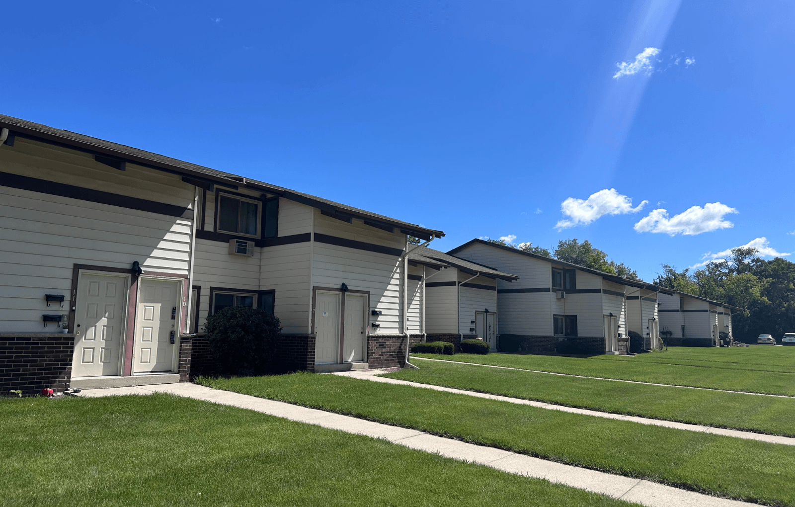 A row of houses with a clear blue sky above them.