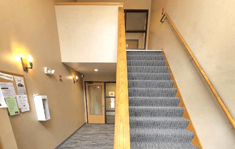 a staircase in a building with a blue carpet