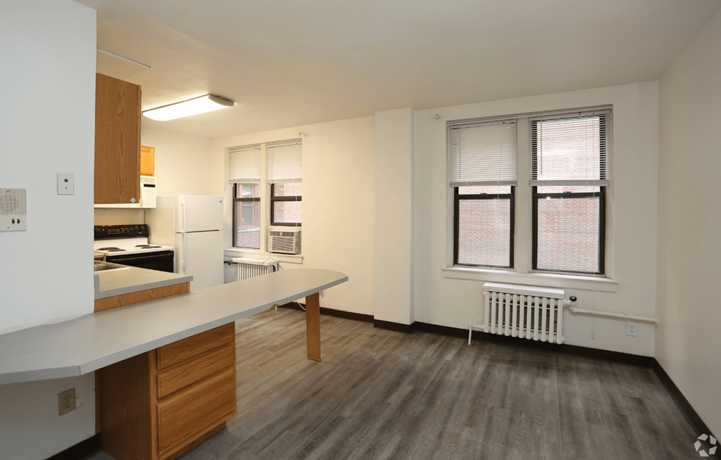 A kitchen with a counter and a window.