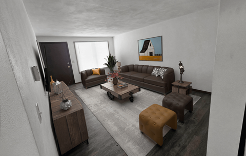 A living room with a brown couch, a coffee table, and a painting on the wall.