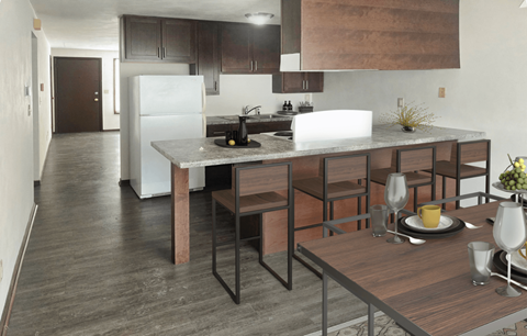 A modern kitchen with a dining table set for two.