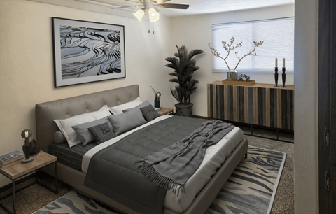 A bedroom with a large bed and a painting on the wall.