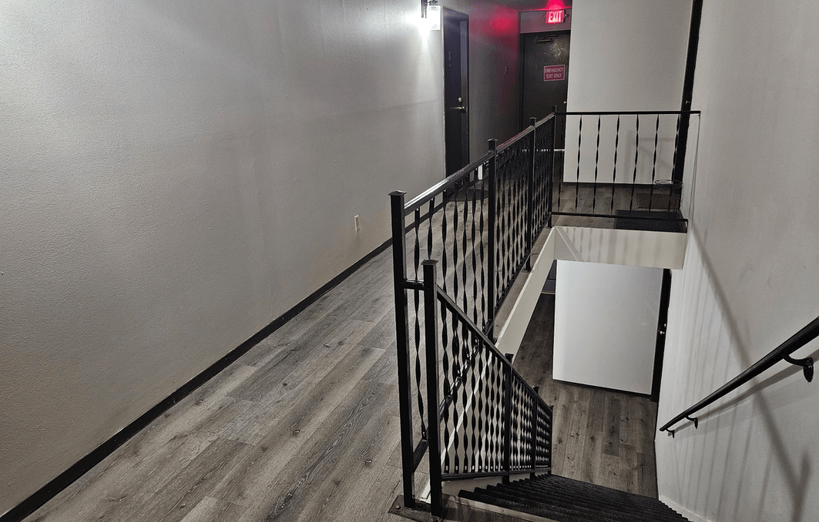 A staircase with a black railing and wooden steps.