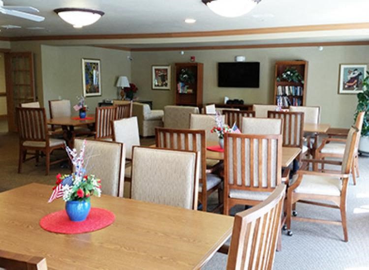 a dining room with a wooden table and chairs