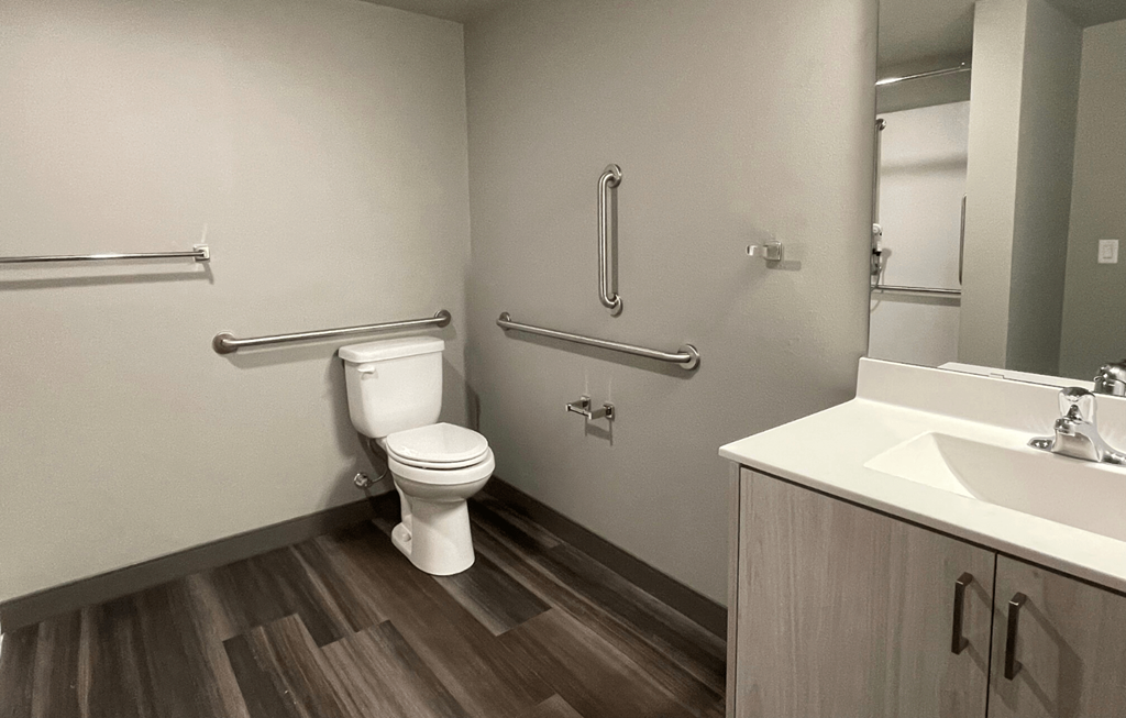 a bathroom with a toilet sink and mirror