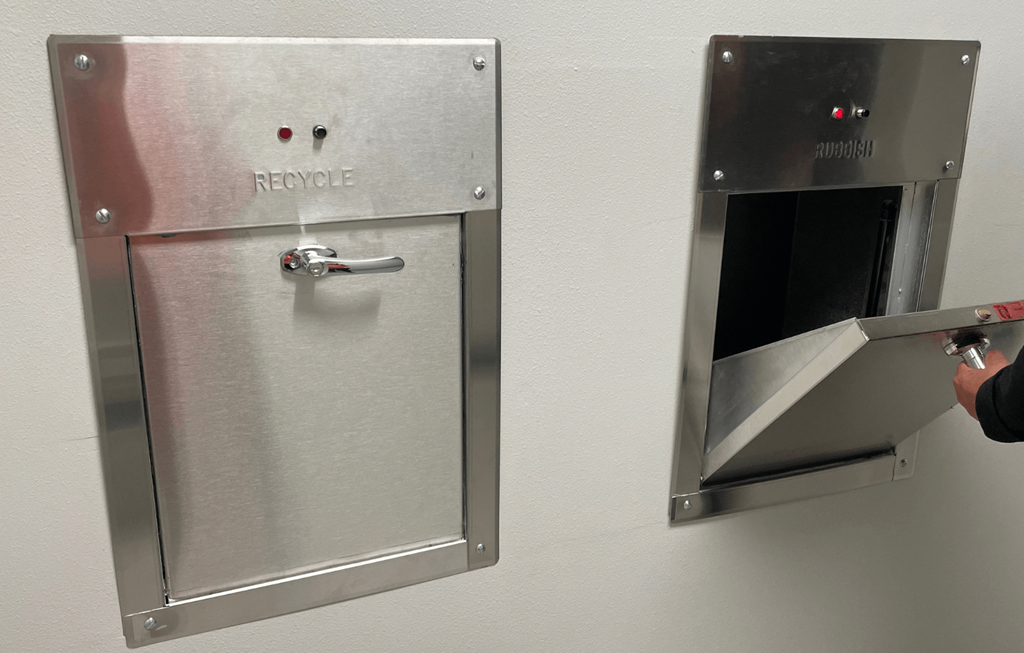 a door on a wall with a handle and a hole in it