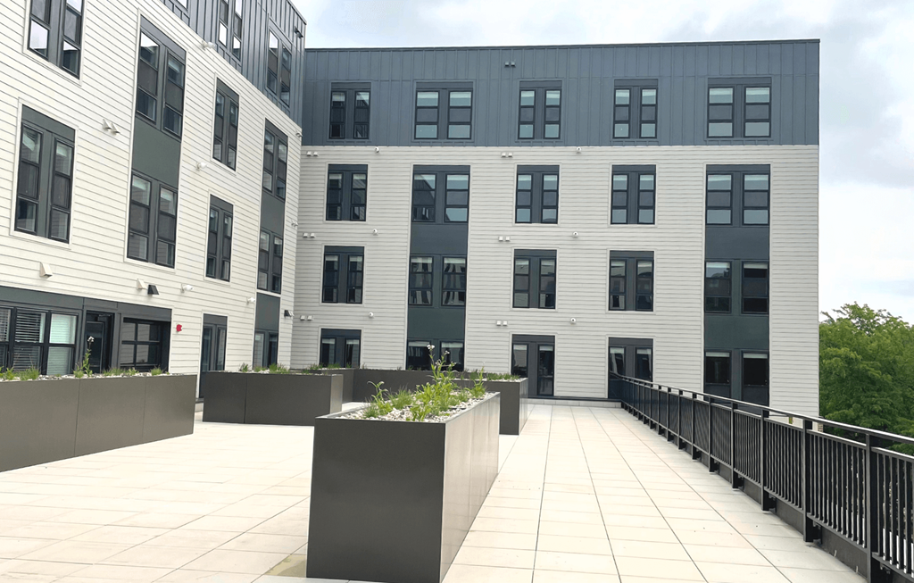 a large white building with a black fence in front of it