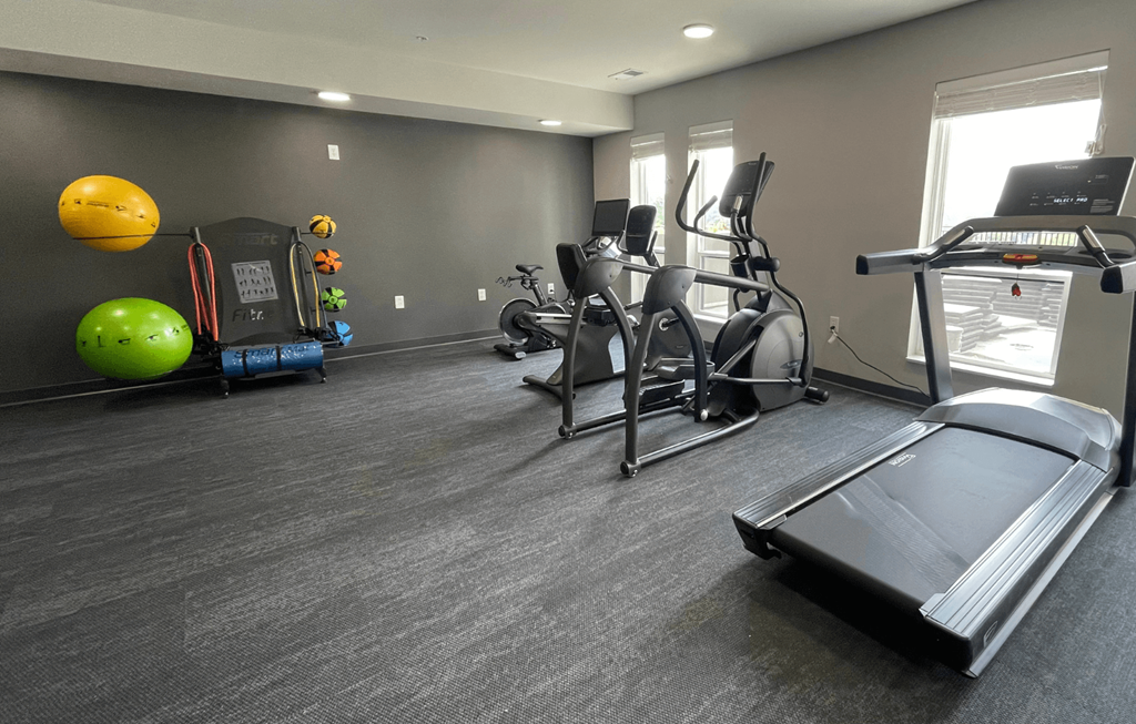 a fitness center with treadmills and other exercise equipment